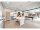 Open kitchen with an island, stainless steel appliances, and a view into the living area at 5989 Rockway Glen Ave, Las Vegas, NV 89141