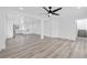 Bright, open living area with wood-look flooring, ceiling fan, and view of the kitchen at 8979 Green Jade Dr, Las Vegas, NV 89129