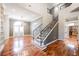 Elegant staircase with wrought iron railing and hardwood floors at 9000 Opus Dr, Las Vegas, NV 89117