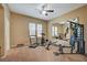 Well-equipped home gym featuring treadmill, exercise bike, and weight machine at 10758 Chillingham Dr, Las Vegas, NV 89183