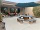 Covered patio with round table, seating, and umbrella at 10758 Chillingham Dr, Las Vegas, NV 89183