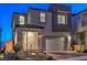 Modern two-story house with gray and brown exterior at night at 10825 Space Odyssey Ave, Las Vegas, NV 89129