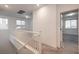 Upstairs hallway with white railings and carpet flooring at 10825 Space Odyssey Ave, Las Vegas, NV 89129