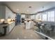 Bright, spacious kitchen featuring white cabinetry, stainless steel appliances, and an island with marble countertop at 11438 Bargetto Ct, Las Vegas, NV 89141