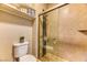 Clean bathroom with a glass shower, tiled walls, and convenient shelving at 1851 Hillpointe Rd # 2321, Henderson, NV 89074