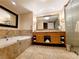 Elegant hotel bathroom with double sinks, soaking tub, and textured walls at 2000 N Fashion Show Dr # 4701, Las Vegas, NV 89109