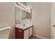 Bathroom vanity area with a mirror, sink, and wood-look cabinetry at 220 Mission Newport Ln # 106, Las Vegas, NV 89107