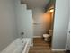 Updated bathroom featuring a soaking tub, toilet, and wood-look flooring at 2291 W Horizon Ridge Pkwy # 5228, Henderson, NV 89052