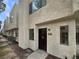 Front exterior view of a two-story home with a brown door and a walkway at 2608 Matogroso Ln, Las Vegas, NV 89121