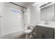 Modern bathroom with gray vanity, white tub, and tiled shower at 3450 Erva St # 165, Las Vegas, NV 89117