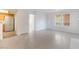 Living room with wood-look tile, white walls, and view to the kitchen at 3450 Erva St # 165, Las Vegas, NV 89117