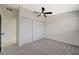 Bedroom with ceiling fan, carpet, and sliding closet doors at 501 Alexander Ave, Las Vegas, NV 89106