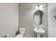 Simple bathroom with pedestal sink and round mirror at 5020 Pioneer Scout St, North Las Vegas, NV 89031