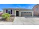 Single-story house with attached garage and landscaping at 5020 Pioneer Scout St, North Las Vegas, NV 89031