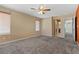 Large bedroom with ceiling fan, carpet, and an ensuite bathroom at 6648 Weeping Pine St, Las Vegas, NV 89149