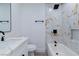 Updated bathroom with marble tile, a modern vanity, and black fixtures at 724 6Th St, Boulder City, NV 89005