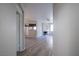 Hallway with wood-look floors offering a view into the living room and kitchen at 8455 W Sahara Ave # 154, Las Vegas, NV 89117