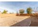 Spacious backyard with a paved patio and desert landscaping at 10318 Glimmering Star Dr, Las Vegas, NV 89178