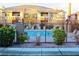 Community pool with surrounding patio and building views at 1050 E Cactus Ave # 1072, Las Vegas, NV 89183