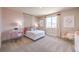 A cozy bedroom with pink accents, a white bed, and a desk at 1922 Molly Brook Dr # Lot 6, North Las Vegas, NV 89084