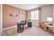 Home office with a dark wood desk, pink accent chair, and built-in shelving at 1922 Molly Brook Dr # Lot 6, North Las Vegas, NV 89084