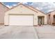 Front exterior of a single-story home with a two-car garage, landscaped yard, and decorative rock accents at 2106 Big Boulder Dr, North Las Vegas, NV 89031