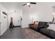 Living room with a fireplace, ceiling fan, and dark tile flooring at 2106 Big Boulder Dr, North Las Vegas, NV 89031