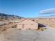 Tan house with brown door and mountain views at 2270 Gally Rd, Pahrump, NV 89060