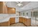 Spacious kitchen featuring wood cabinetry, white appliances, and a center island at 2727 Coventry Green Ave, Henderson, NV 89074