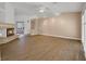 Spacious living room with wood-look flooring, fireplace, and ceiling fan at 2727 Coventry Green Ave, Henderson, NV 89074