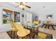 Dining area with glass table, yellow chairs, and a view of the living room at 2820 Linkview Dr, Las Vegas, NV 89134