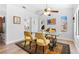 Dining area with glass-topped table, yellow chairs, and hardwood floors at 2820 Linkview Dr, Las Vegas, NV 89134