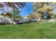 Spacious backyard with a lush green lawn and garden area at 3138 Laurel Ave, Henderson, NV 89014