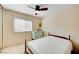 Bedroom with carpeted floors, ceiling fan, a window, and painted dresser at 3138 Laurel Ave, Henderson, NV 89014