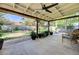 Covered backyard patio featuring ceiling fan, seating area, and decorative plants at 3138 Laurel Ave, Henderson, NV 89014