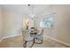 Dining room with table and chairs, a window view, chandelier lighting, and access to the kitchen at 3138 Laurel Ave, Henderson, NV 89014