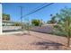 Desert landscaped backyard with a covered patio and block wall at 4425 Stacey Ave, Las Vegas, NV 89108