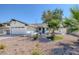 White single-story home with a two-car garage, desert landscaping, and palm trees at 4425 Stacey Ave, Las Vegas, NV 89108