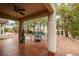 Covered patio with ceiling fan, outdoor furniture, and desert landscaping at 488 Eagle Vista Dr, Henderson, NV 89012