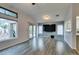 Living area with sliding glass doors to the backyard, ceiling fan, wood-look floors, and plenty of natural light at 488 Eagle Vista Dr, Henderson, NV 89012