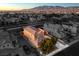 Aerial view of two-story house with tile roof and backyard patio at 5833 Addy Ln, North Las Vegas, NV 89081