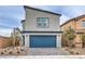 Two-story home with blue garage door, paved driveway, and desert landscaping at 594 Juniper Rock St # Lot 59, North Las Vegas, NV 89081