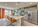 Modern kitchen featuring an island, stainless appliances, and light wood floors at 594 Juniper Rock St # Lot 59, North Las Vegas, NV 89081