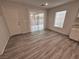 Dining area with wood-look tile flooring, a sliding glass door, and access to the kitchen at 8381 Transvaal Blue St, Las Vegas, NV 89139