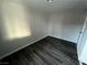 Empty bedroom with dark wood-look flooring at 1000 Hart Ave, Las Vegas, NV 89106