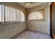 Spacious sunroom with ceiling fan, arched windows, and neutral carpeting at 1402 Santa Margarita St # H, Las Vegas, NV 89146