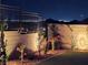 Landscaped backyard with lighting at night at 144 Juliette Pointe Ln, Henderson, NV 89011