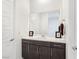 Clean bathroom with dark vanity and large mirror at 144 Juliette Pointe Ln, Henderson, NV 89011