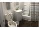 Clean bathroom with white vanity, bathtub, and striped shower curtain at 158 Copper St, Henderson, NV 89015