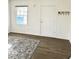 Bright living room with wood-look floors and a decorative rug at 158 Copper St, Henderson, NV 89015